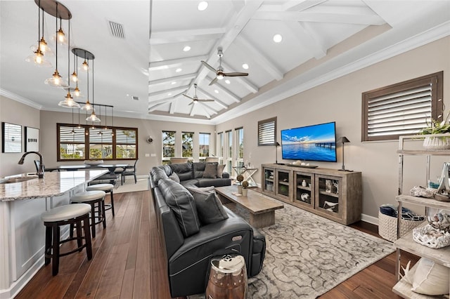 living room featuring ceiling fan, sink, lofted ceiling with beams, dark hardwood / wood-style floors, and crown molding