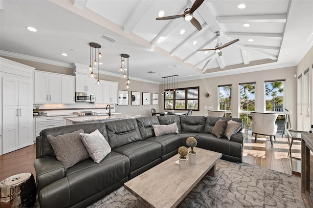 living room with sink, crown molding, vaulted ceiling with beams, ceiling fan, and dark hardwood / wood-style flooring