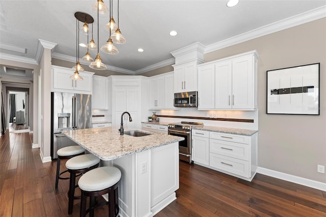 kitchen with white cabinetry, sink, an island with sink, decorative light fixtures, and appliances with stainless steel finishes