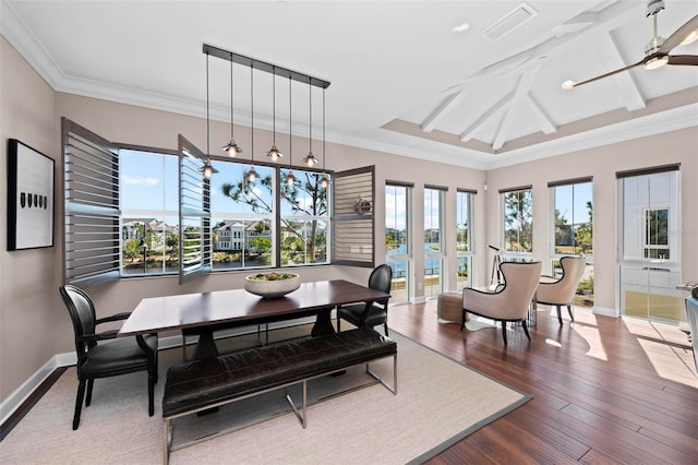 dining room with crown molding, ceiling fan, and dark wood-type flooring