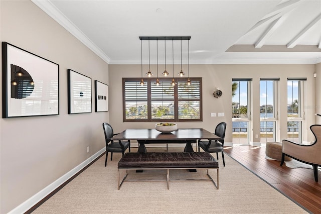 dining area with hardwood / wood-style flooring, plenty of natural light, and ornamental molding