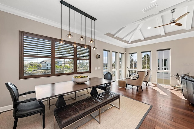 dining area with ceiling fan, wood-type flooring, a healthy amount of sunlight, and ornamental molding