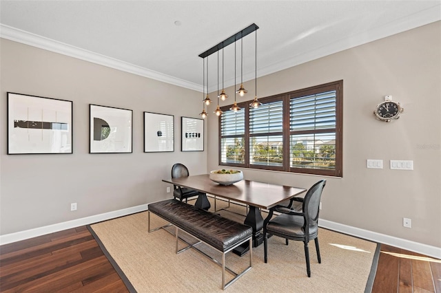 dining space with crown molding and dark wood-type flooring