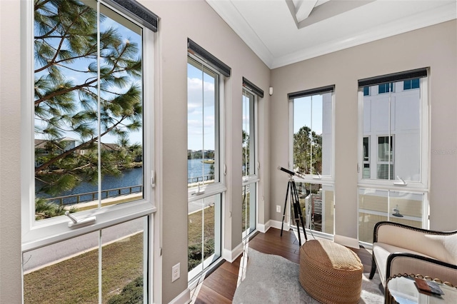 sunroom / solarium with a water view