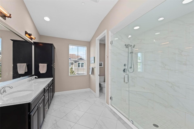 bathroom with vanity, toilet, a shower with shower door, and vaulted ceiling