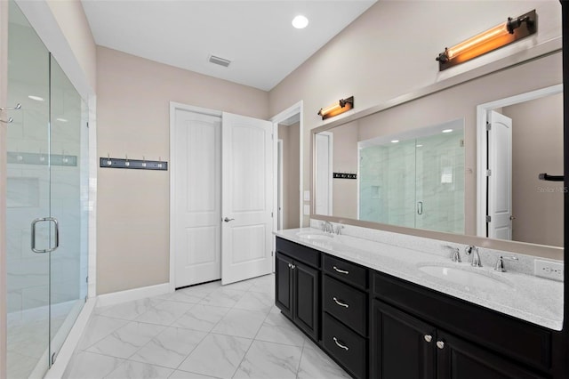 bathroom with vanity and a shower with shower door