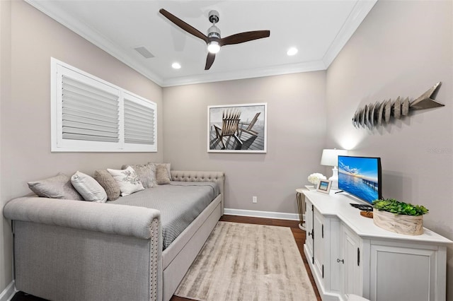 bedroom with ceiling fan, crown molding, and light hardwood / wood-style flooring