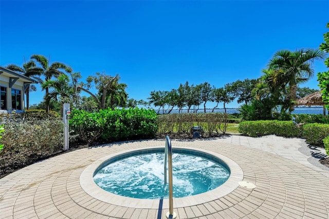 view of swimming pool with an in ground hot tub