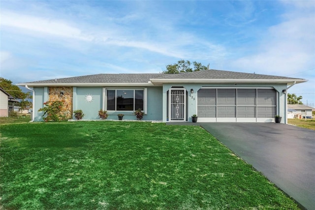 single story home featuring a front yard and a garage