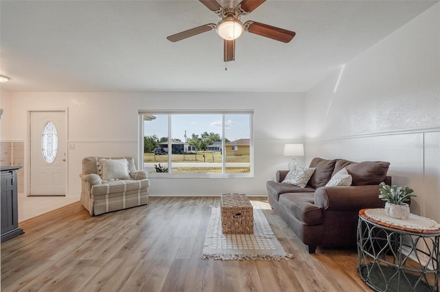 living room featuring light hardwood / wood-style flooring and ceiling fan