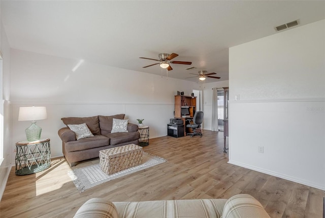 living room featuring ceiling fan and light wood-type flooring