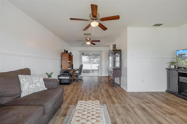 living room featuring ceiling fan and light hardwood / wood-style flooring