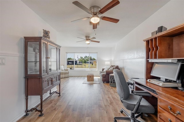 office with ceiling fan and light hardwood / wood-style floors