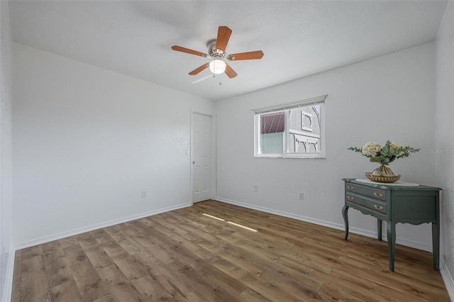 spare room with hardwood / wood-style floors and ceiling fan