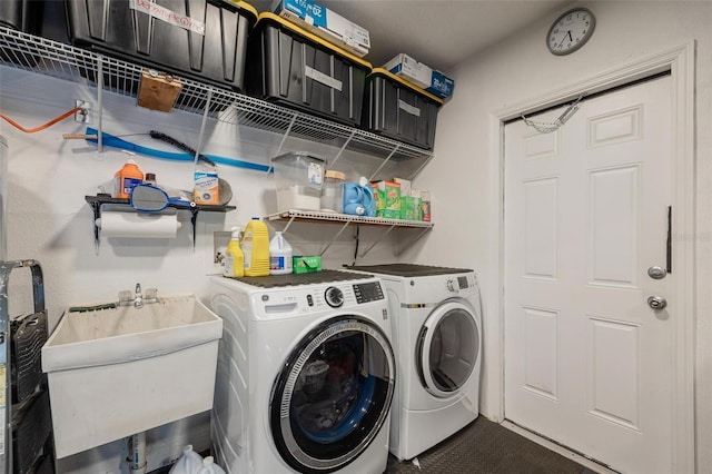 laundry room featuring washing machine and clothes dryer and sink