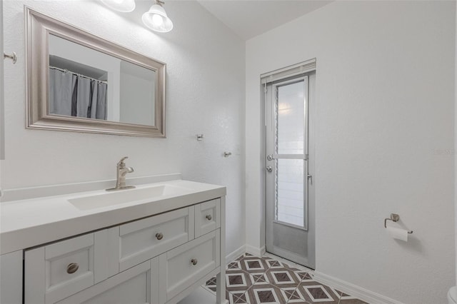 625 Ennis Ter NW, Port Charlotte, FL 33952 - bathroom featuring baseboards and vanity