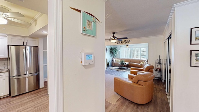 interior space with crown molding and light wood-type flooring