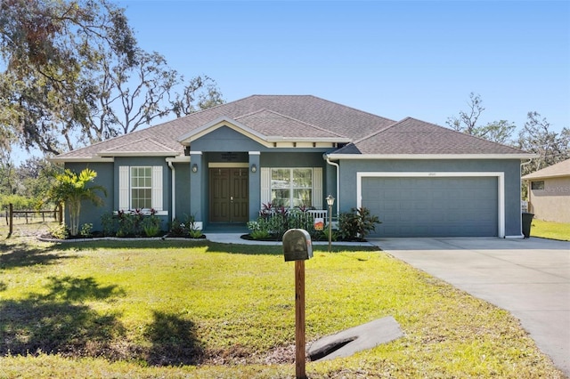 view of front of home with a front yard and a garage