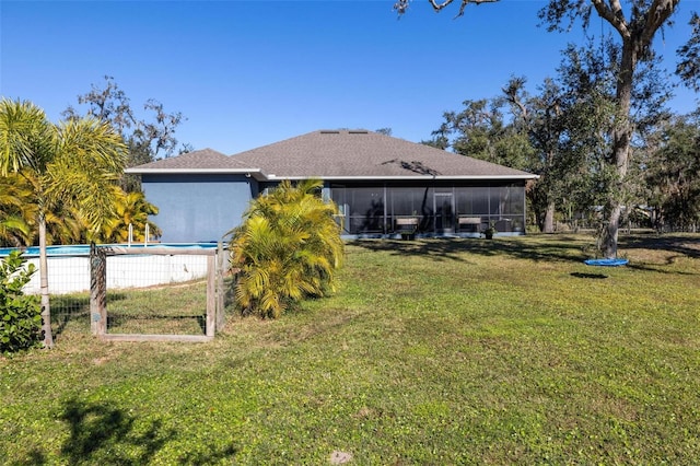 view of yard featuring a sunroom and a fenced in pool