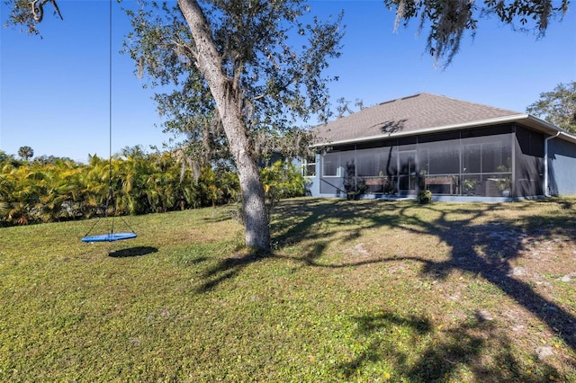 view of yard with a trampoline and a sunroom