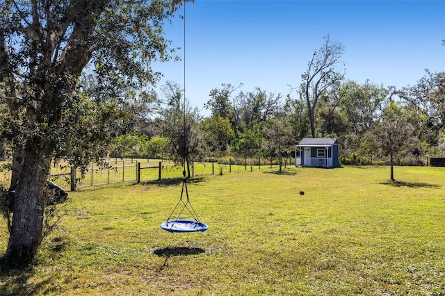 view of yard featuring a rural view and a storage unit