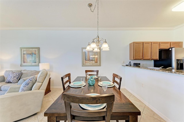 dining space with crown molding, light tile patterned floors, and a chandelier