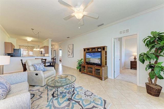 tiled living room with crown molding and ceiling fan with notable chandelier