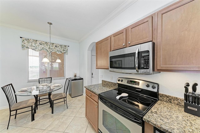 kitchen featuring pendant lighting, dark stone countertops, ornamental molding, stainless steel appliances, and a chandelier