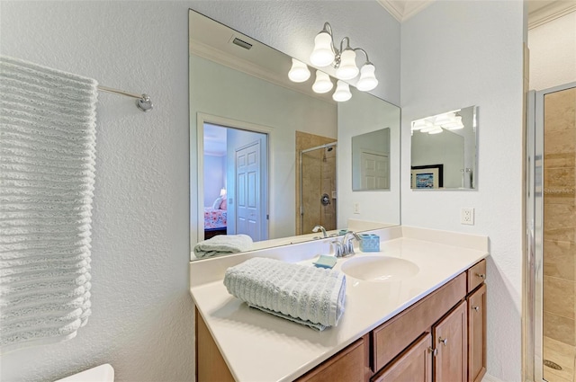 bathroom with crown molding, a shower with door, vanity, and an inviting chandelier