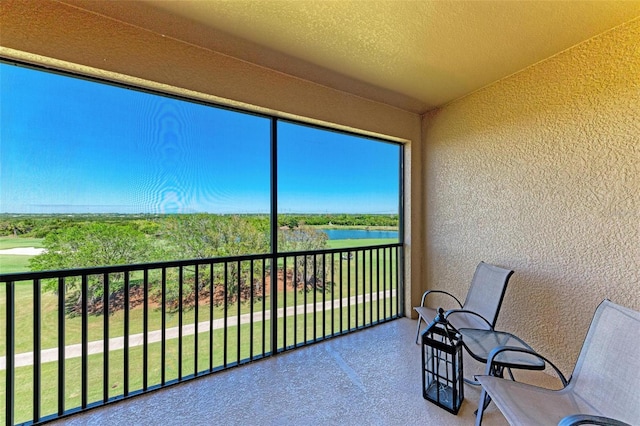 unfurnished sunroom with a water view