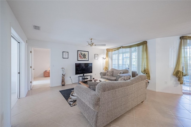 tiled living room with ceiling fan