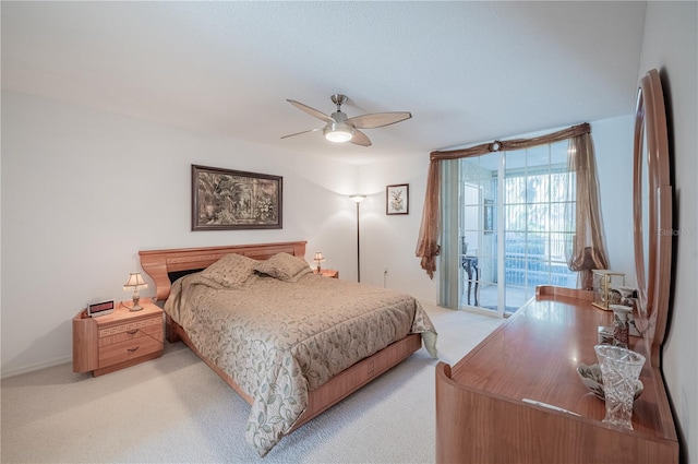 bedroom with ceiling fan, access to exterior, and light carpet