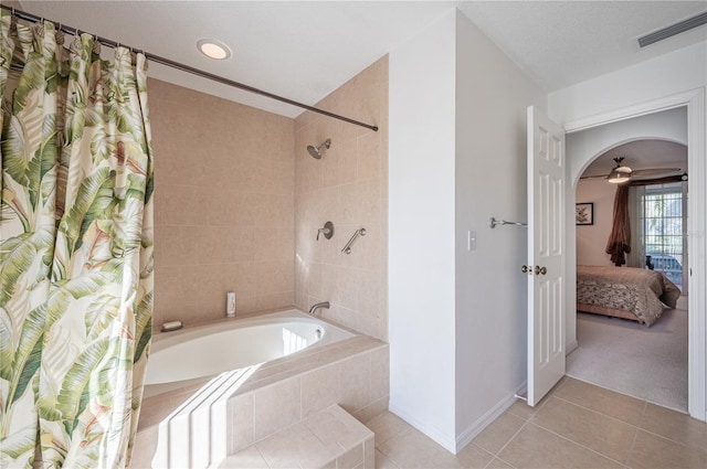 bathroom with shower / tub combo, tile patterned floors, ceiling fan, and a textured ceiling