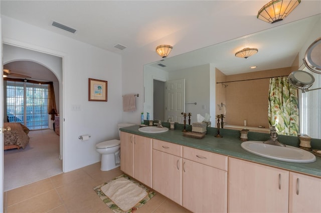 bathroom featuring vanity, a shower with curtain, tile patterned floors, and toilet