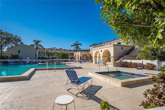 view of pool featuring a patio area and a hot tub