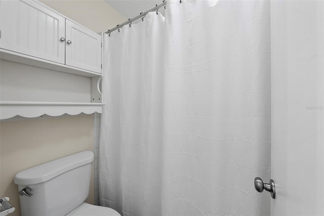 bathroom featuring toilet and a textured ceiling