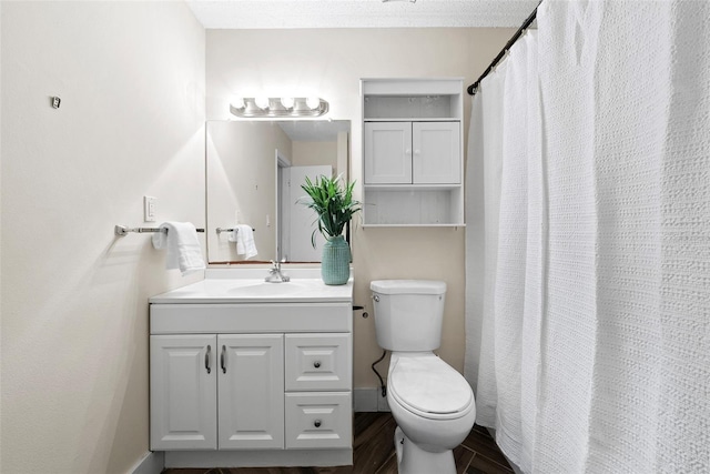 bathroom featuring hardwood / wood-style flooring, vanity, and toilet