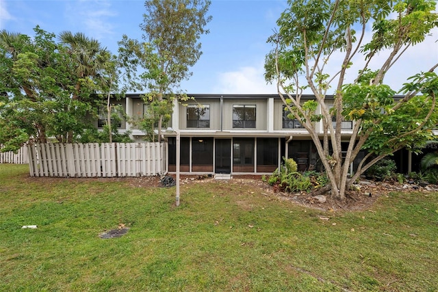 rear view of house featuring a sunroom