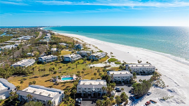 bird's eye view with a water view and a beach view