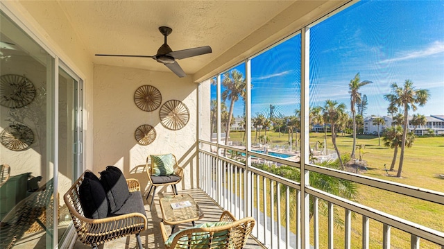 sunroom / solarium with plenty of natural light and ceiling fan