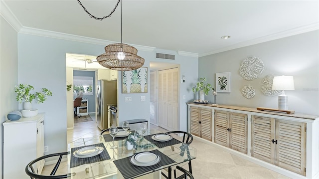 dining room with light tile patterned floors, visible vents, and crown molding