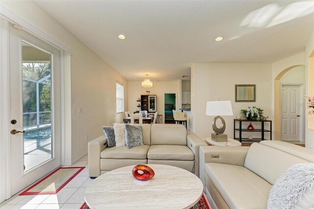 living area featuring arched walkways, a wealth of natural light, and recessed lighting