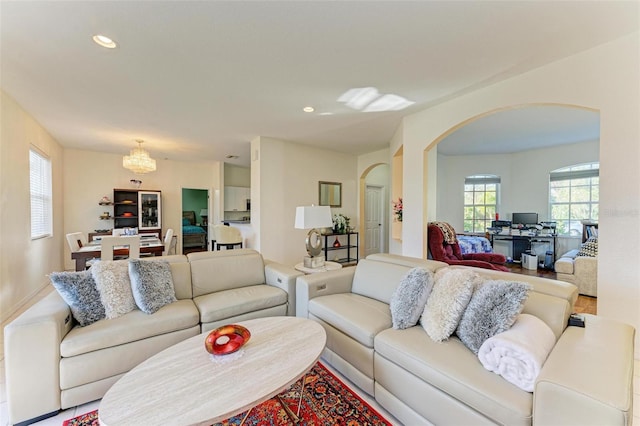 living room with arched walkways and recessed lighting