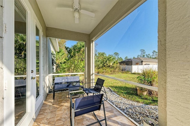 sunroom featuring ceiling fan