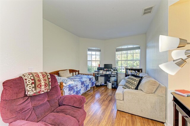 bedroom with visible vents and wood finished floors