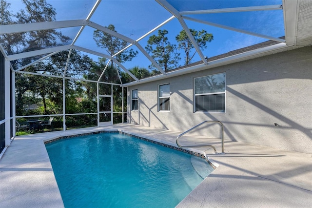 outdoor pool featuring a patio area and a lanai