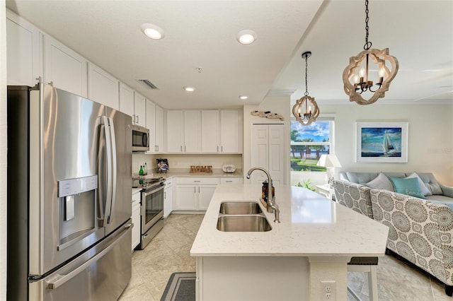 kitchen featuring white cabinets, sink, decorative light fixtures, appliances with stainless steel finishes, and a notable chandelier