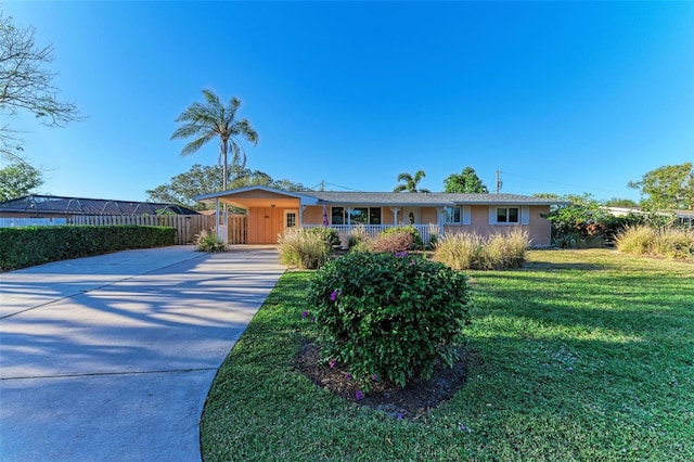 ranch-style house featuring a carport and a front yard