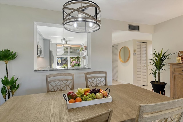 dining area featuring an inviting chandelier