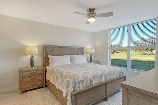 bedroom with light wood-type flooring and ceiling fan